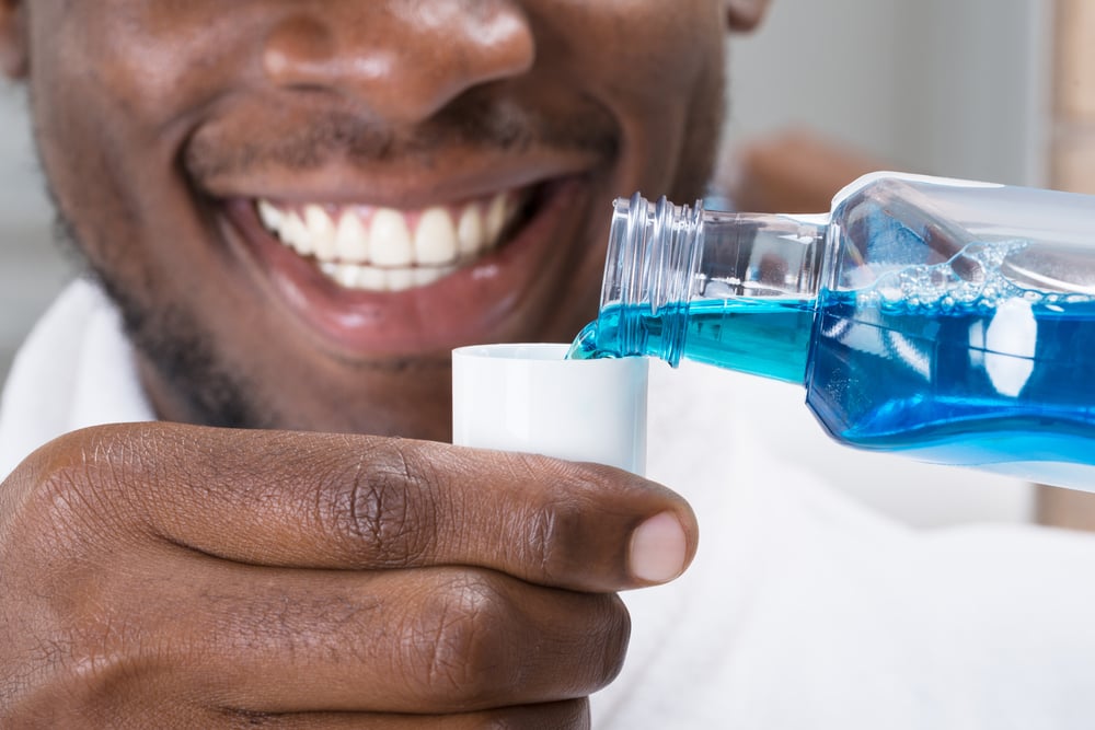 An image of a patient using mouth wash